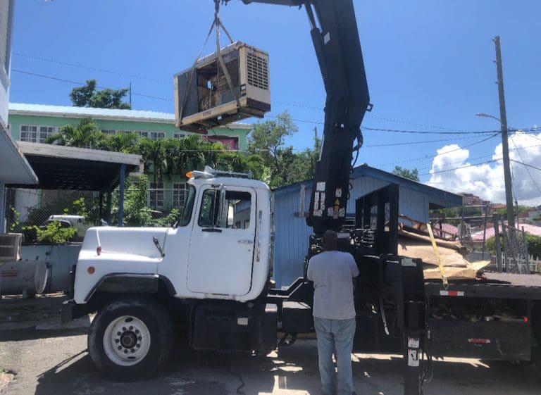 Volunteers Replace Generator at STJ Storm Shelter