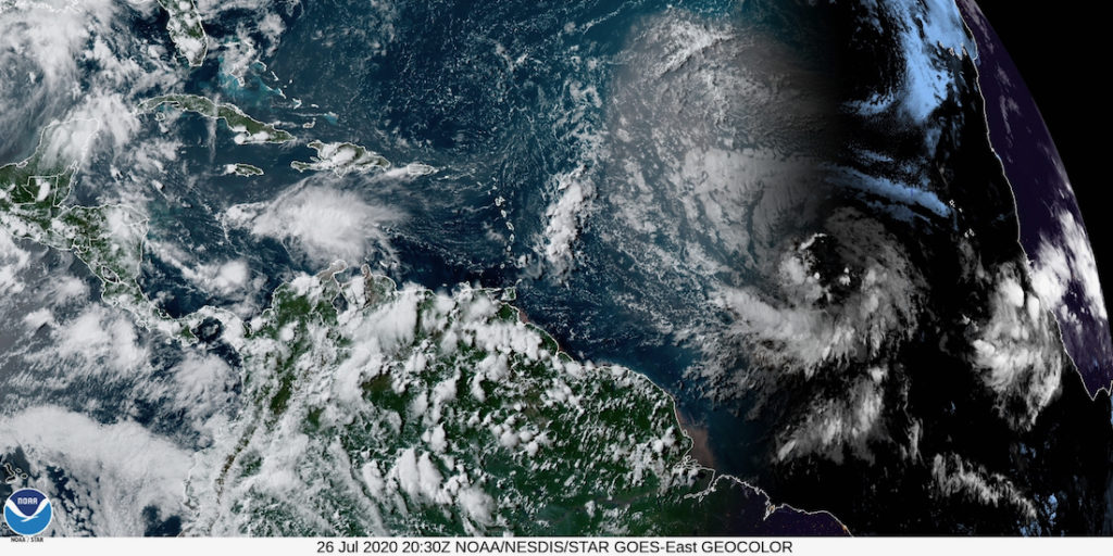 Satellite photo shows the remnant of Gonzalo blowing off to the left, while Invest 92-L comes across from the right, heading for the Caribbean. (NOAA satellite photo)