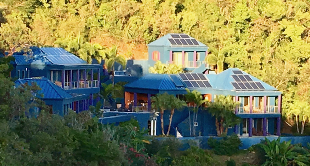 Solar panels cover the roof of a St. John hillside home.