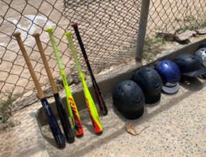 Gear for the game is lined up carefully in the D.C. Canegata Ballpark dugout. (Anne Salafia photo