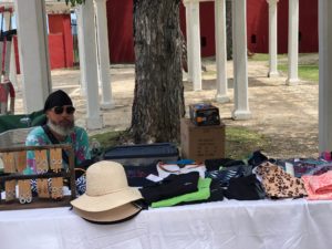 A vendor has clothing, sun hats, jewelry and other souvenirs for sell at the Frederiksted Clock Tower. (Source photo by Susan Ellis)