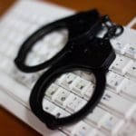 Cybercrime_-_keyboard_and_handcuffs