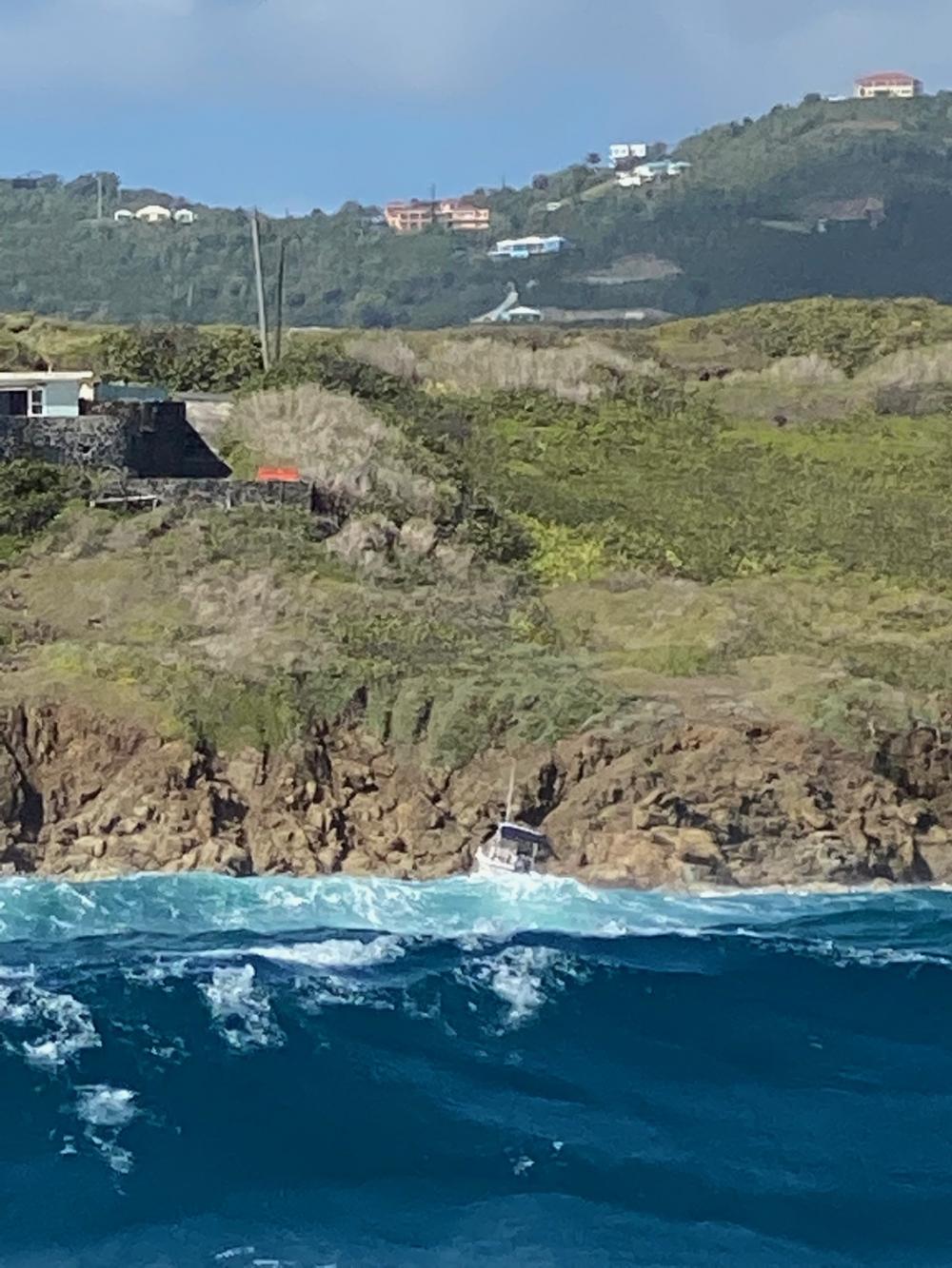 The vessel Katana sits on the rocks off Judith's Fancy, St. Croix, on Monday. Nine people were rescued from the boat on Sunday evening after it ran out of fuel and was drifting toward the reef line, according to the Coast Guard. (Photo courtesy of U.S. Coast Guard District 7 PADET San Juan)