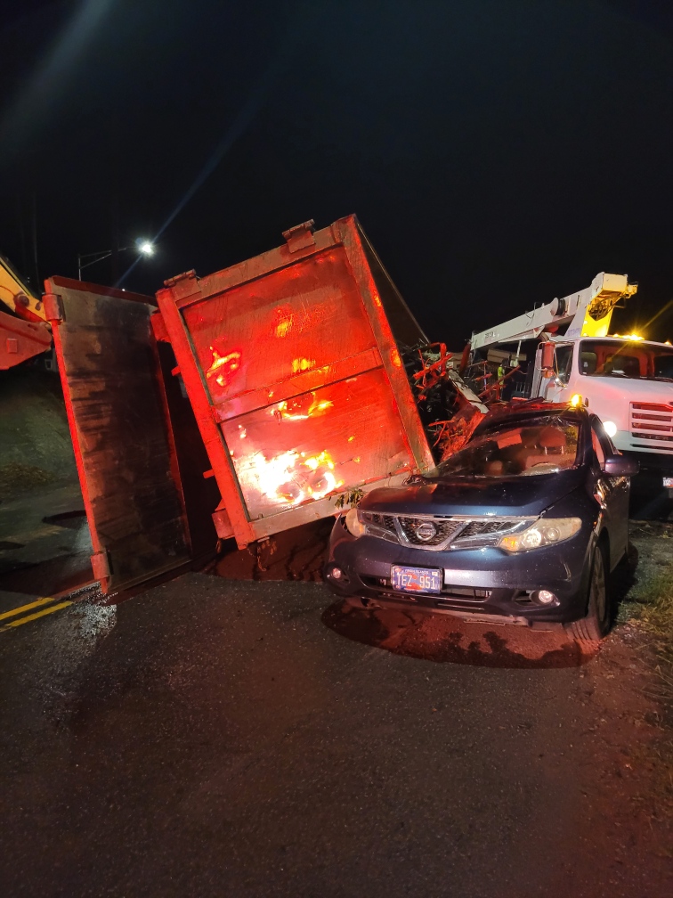 Truck Carrying Garbage Bin Filled with Dirt Collides with SUV