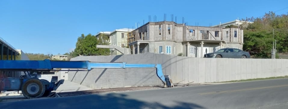 The immense structure built right up to residential homes , which block view of residents. This is a good example of property devalued due the huge structure. (Photo by Olasee Davis)