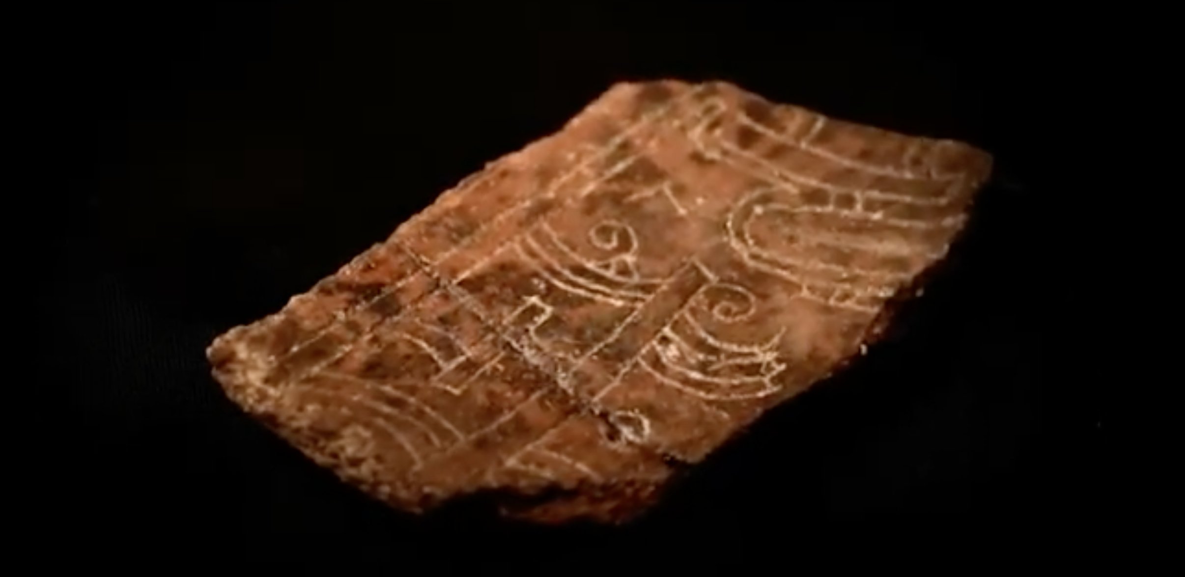 A fragment of pottery with an intricate design was found below Main Street. (Screenshot from the Charlotte Amalie Saladoid Excavation documentary)