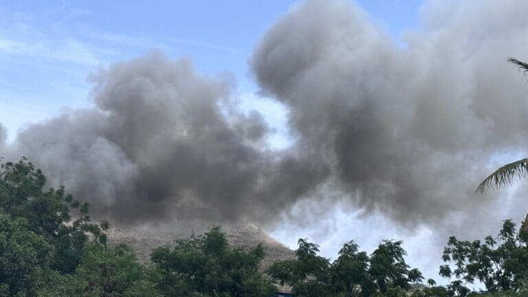 Thick black smoke fills the air after a fire broke out Friday at the Bovoni landfill on St. Thomas. (Source photo by Michele Weichman)