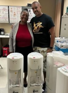 St. Croix Career and Technical Education Center Assistant Principal Sharon Charles, left, and Rashidi Clenance with donations of water coolers for the school. (V.I. Education Department photo)