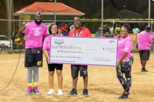 The DEMUS Foundation donates $1,500 to Mamba Mentality after last year’s Benny-Demus Carnival Kickball Tournament. From left, Benny-Demus, Ardrianna Hendricks, Jed Elizee, and Ebony Hill (Photo courtesy Gemini Productions VI)