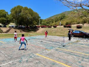 Children playing at a pop-up pickleball station, one of the many on-site activity stations. (Source photo by Nyomi Gumbs)