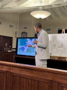 Architect Gilbert Laban shows a map of three-story structures within the Cruz Bay Historic District. (Source photo by Amy H. Roberts)