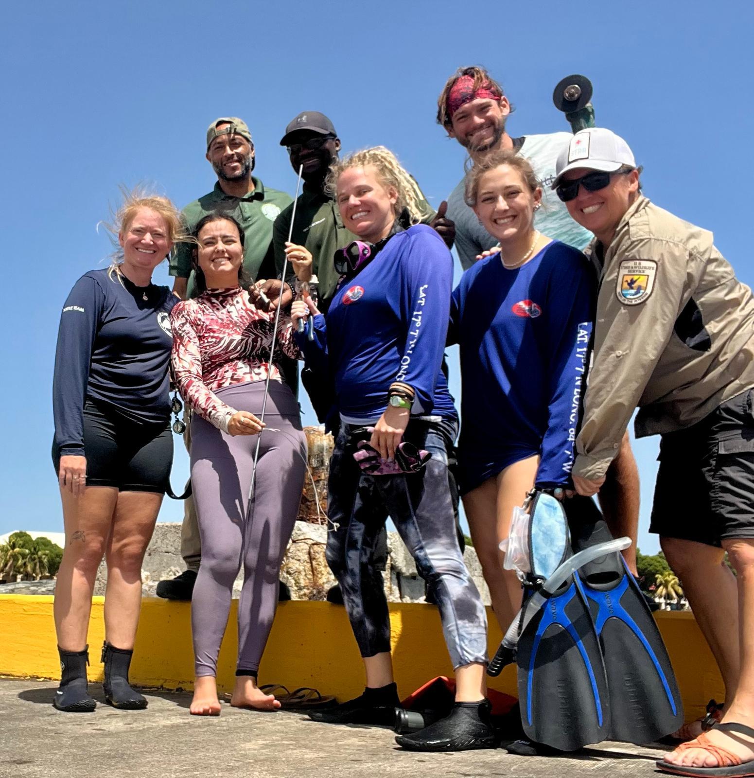 STAR responders with the recovered spear, including team members from the U.S. Fish and Wildlife Service, DPNR, the St. Croix Sea Turtle Project, and St. Croix Ultimate Bluewater Adventures. (Photo courtesy STAR)