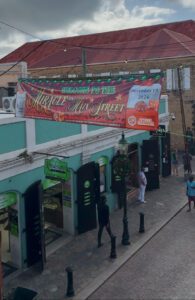 A banner announcing the 2024 Miracle on Main Street hangs above downtown Charlotte Amalie during last year’s event preparations.