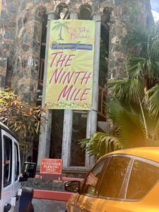 A colorful banner hung at Mongoose Junction Shopping Center marks the gathering place for athletes taking part in 8 Tuff Miles on Friday. (Source photo by Judi Shimel)