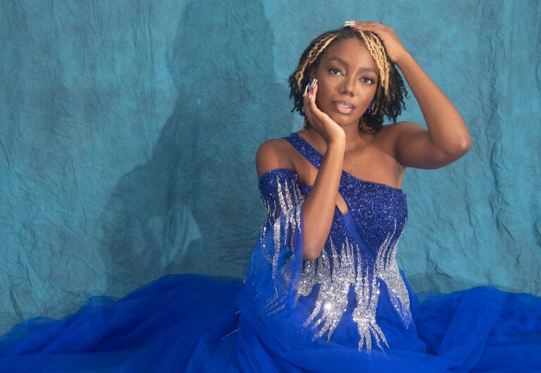Majestik Freedom poses for picture wearing a sequined blue dress, sash, and crown. (Photo courtesy Winx Flix Photography)