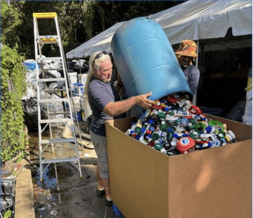 Island Green recycling crew members John Baker and CJ Scatliffe prepare ocean-bound plastic for shipment. (Photo courtesy Island Green Living)