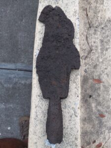 This artifact, found in Maroon Country, is known as a "sugar cane knife." or a "cane knife.” Dated to the 1800s, it was used by enslaved Africans, Maroons, and "free slaves" up until the 19th century in the sugarcane fields of St. Croix. The cane knife is also used as a symbol of resistance. (Photo by Olasee Davis)